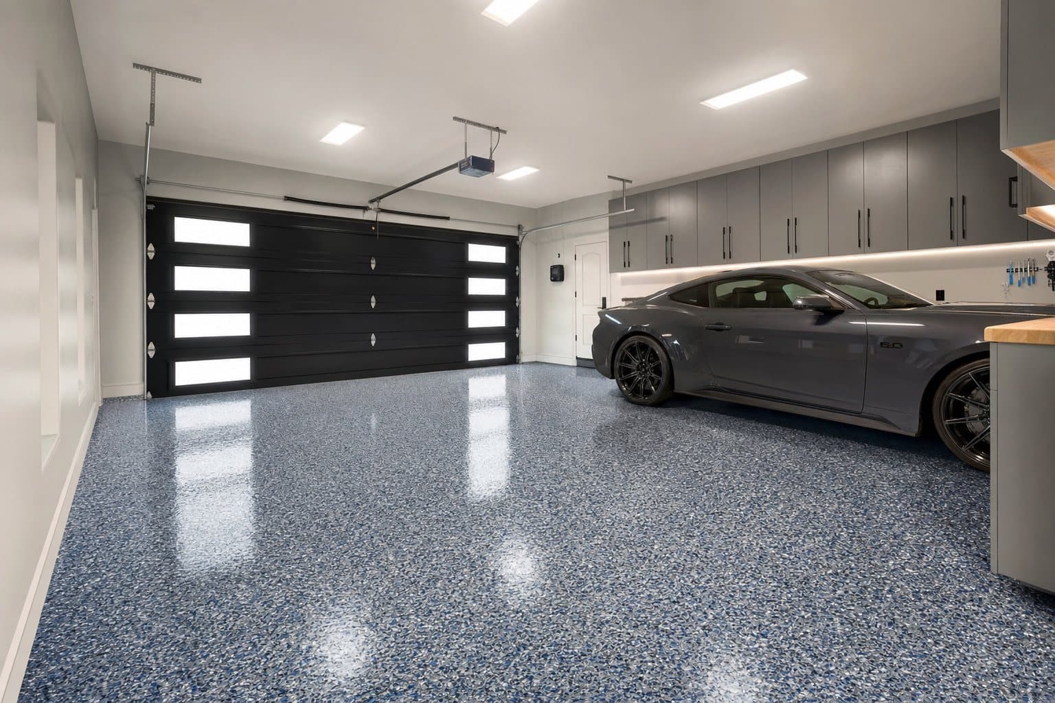 Premium residential garage with blue decorative-flake concrete floor coating